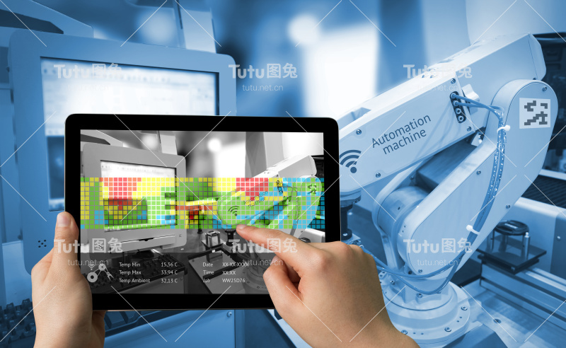 工业4.0概念。带有增强现实屏幕软件的手持式平板电脑和智能工厂背景下的自动化无线机器人手臂的蓝色调